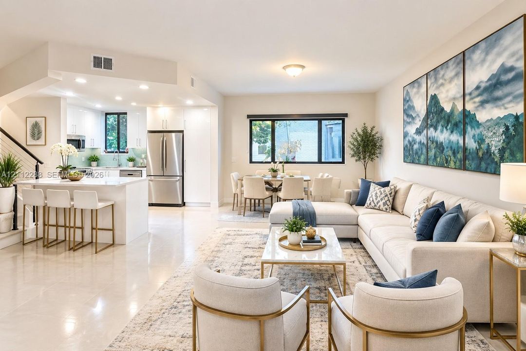 Open-concept living space featuring high-gloss cabinetry, stainless steel appliances, a kitchen island with stone countertops, and polished tile flooring