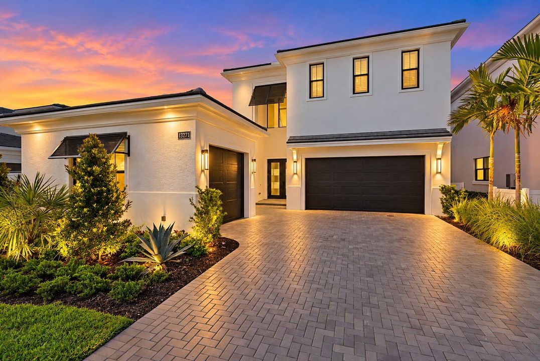 Twilight Luxury Home with Glowing Landsc
