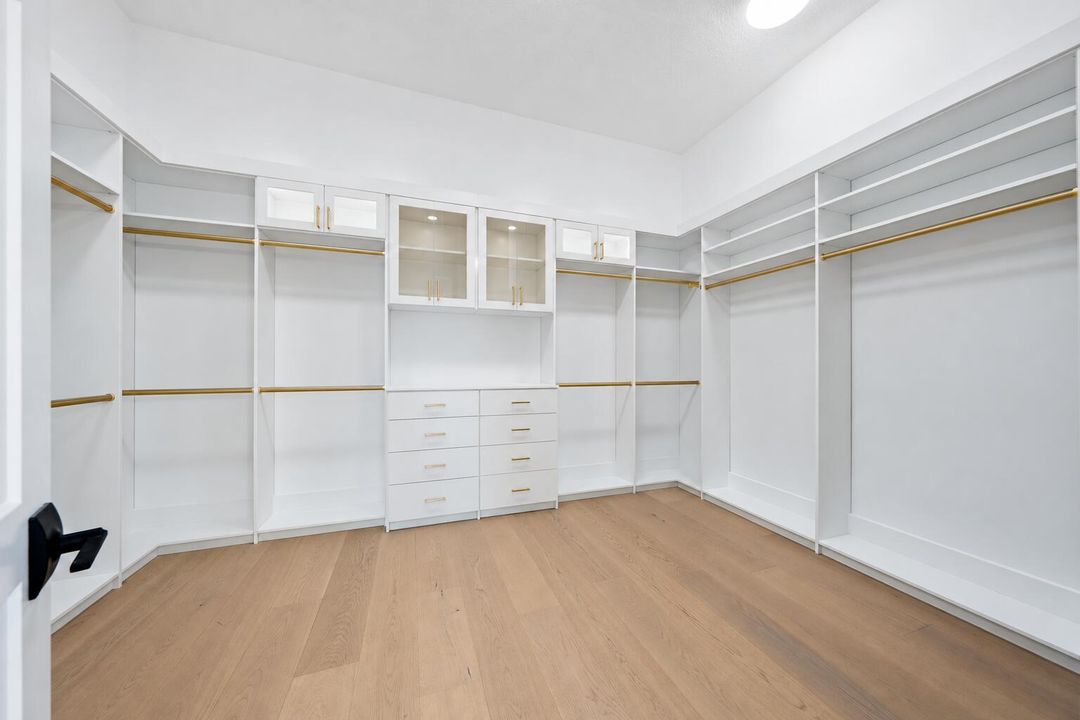 Minimalist White Walk-In Closet with Bra