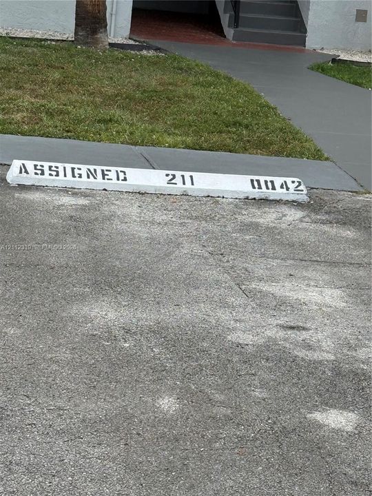 Designated concrete parking space with painted identification marker