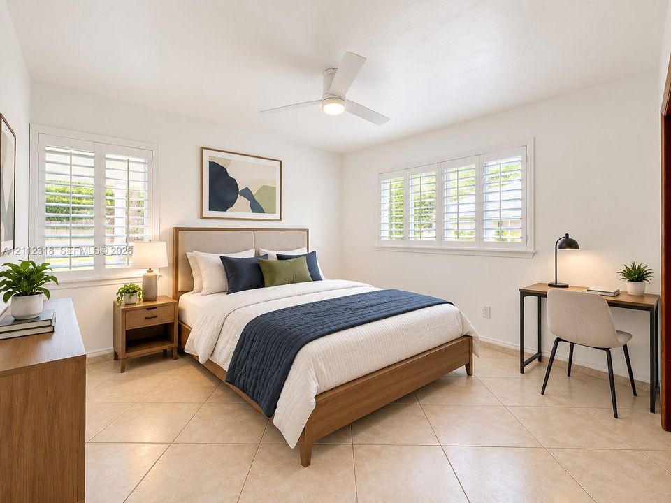 Neutral-tone tile flooring, white plantation shutters, and a central ceiling fan with integrated lighting