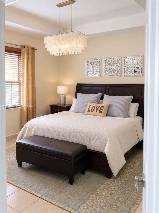 Tray ceiling, multi-tiered white pendant chandelier, and large-format tile flooring