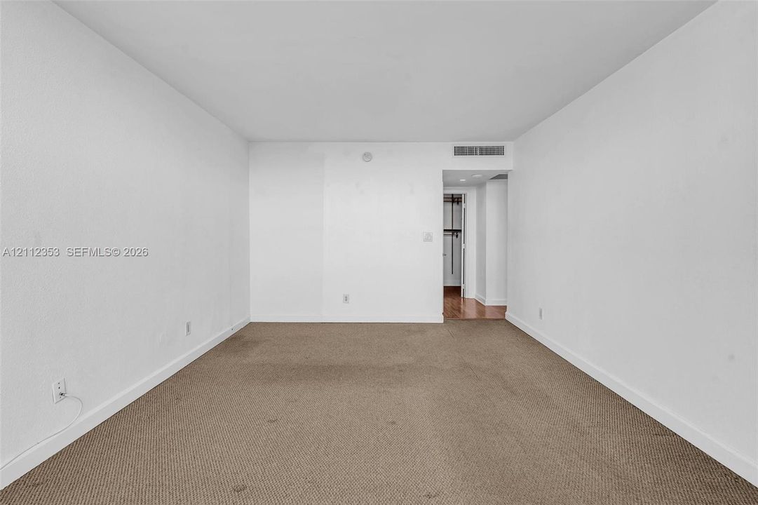 Interior space featuring neutral wall-to-wall carpeting and smooth white walls