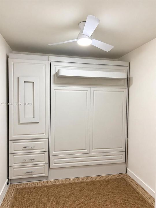 Built-in wall unit featuring a Murphy bed with storage and desk
