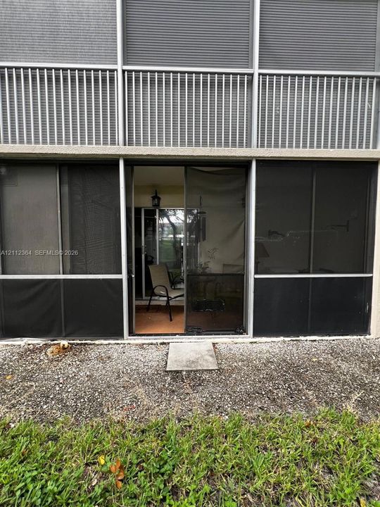 Screened-in patio featuring metal framing and a sliding glass door entry