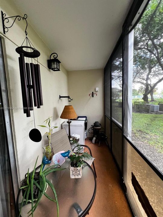 Screened-in porch featuring full-length screen panels, solid flooring, wall-mounted exterior lighting, and mounting hardware