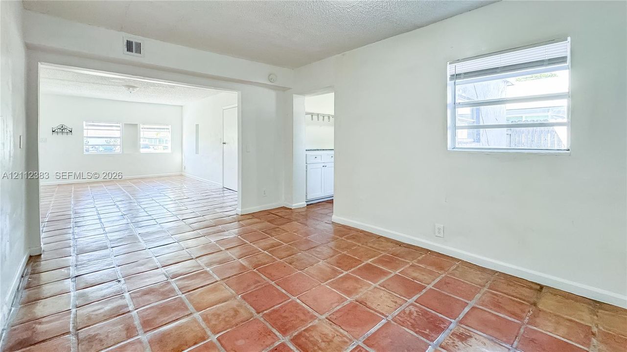 Ceramic tile flooring, horizontal slat windows, and painted walls