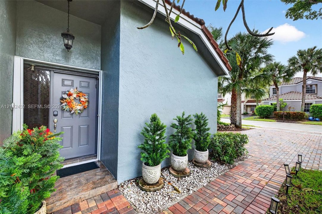 Entry featuring paver stone walkway