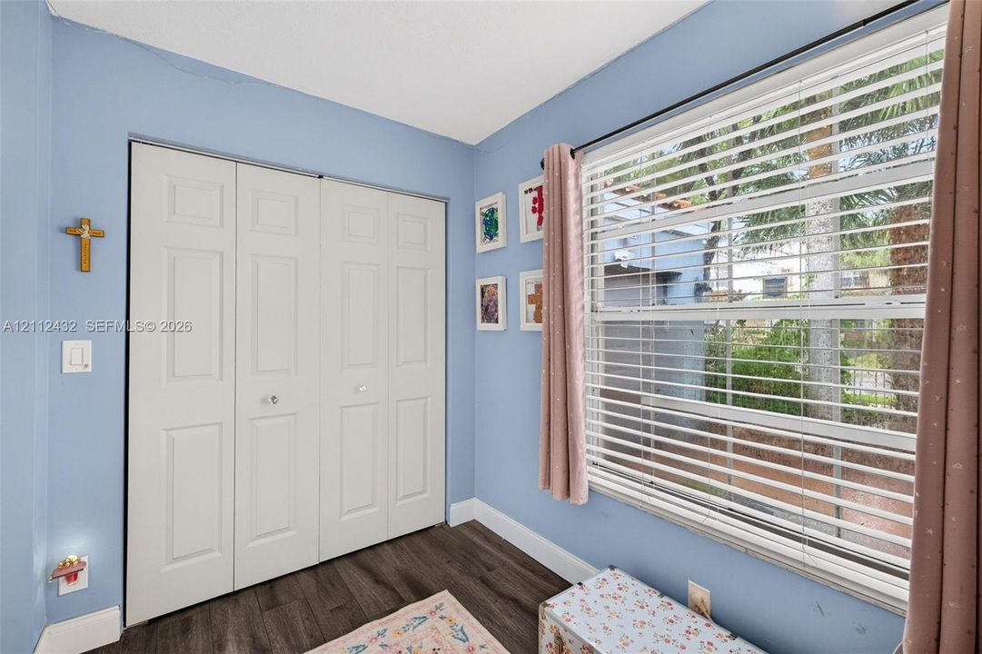 Room featuring wood-look flooring and large closet