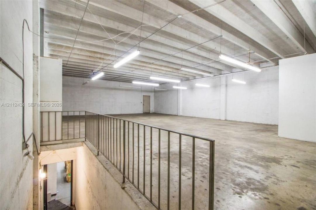 Second floor, 16 ft ceilings. 2021 photo, digitally edited to show it vacant, as today