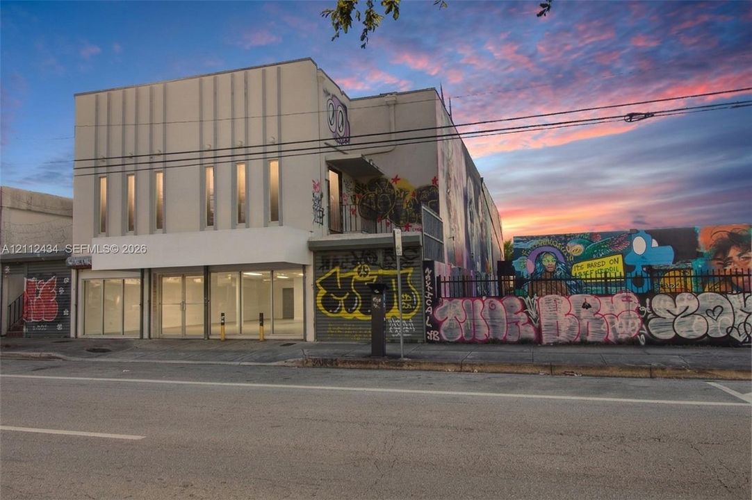 Front at twilight. 2021 photo, digitally edited: former tenant's signs and displays removed