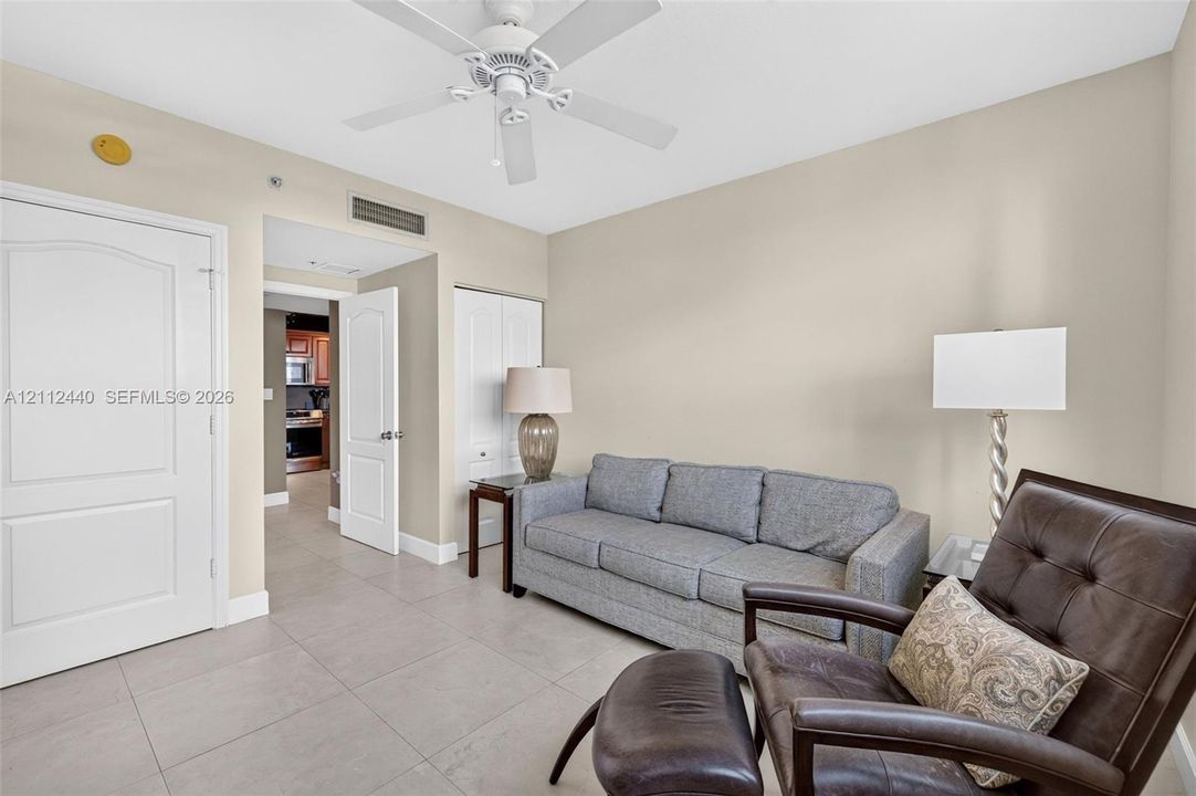 Neutral-toned interior featuring large-format flooring & 2 closets