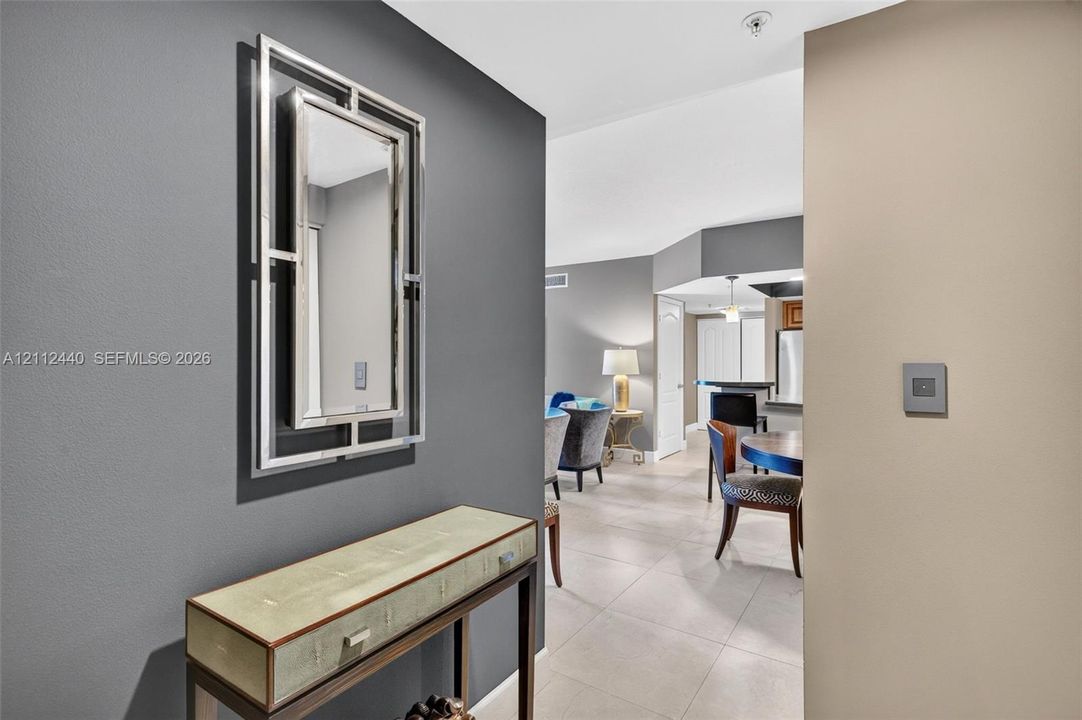 Designer selected paint on interior featuring high ceilings, minimalist grounted porcelain flooring, and accent-painted walls