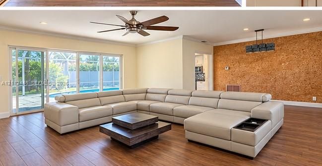 Living area featuring wood-finish flooring, a textured accent wall, recessed lighting, a ceiling fan, and large sliding glass doors