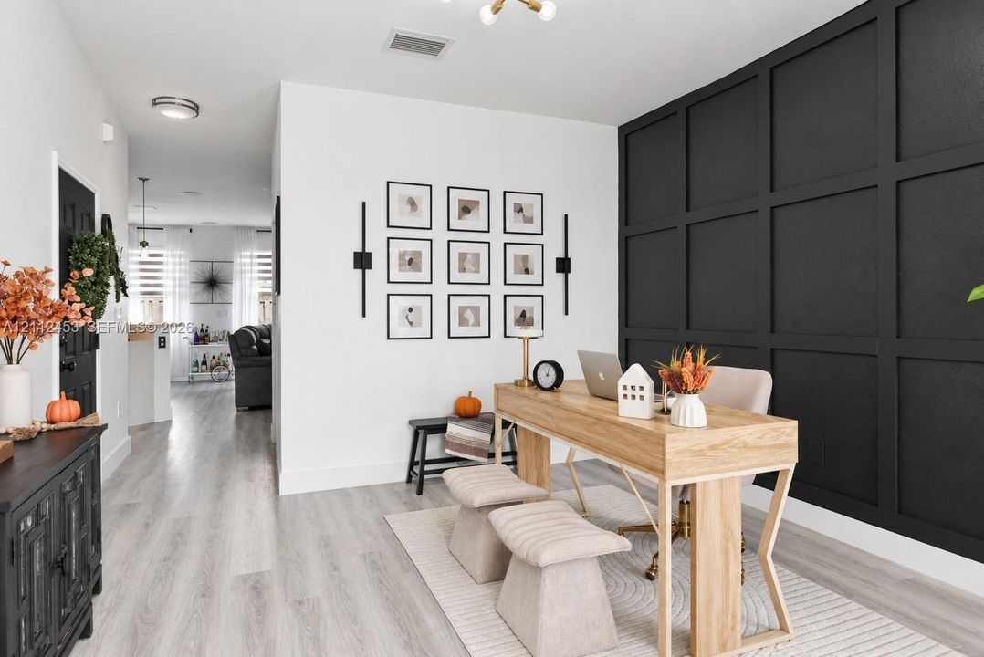 Board and batten accent wall, wood-finish flooring, and minimalist wall-mounted light fixtures