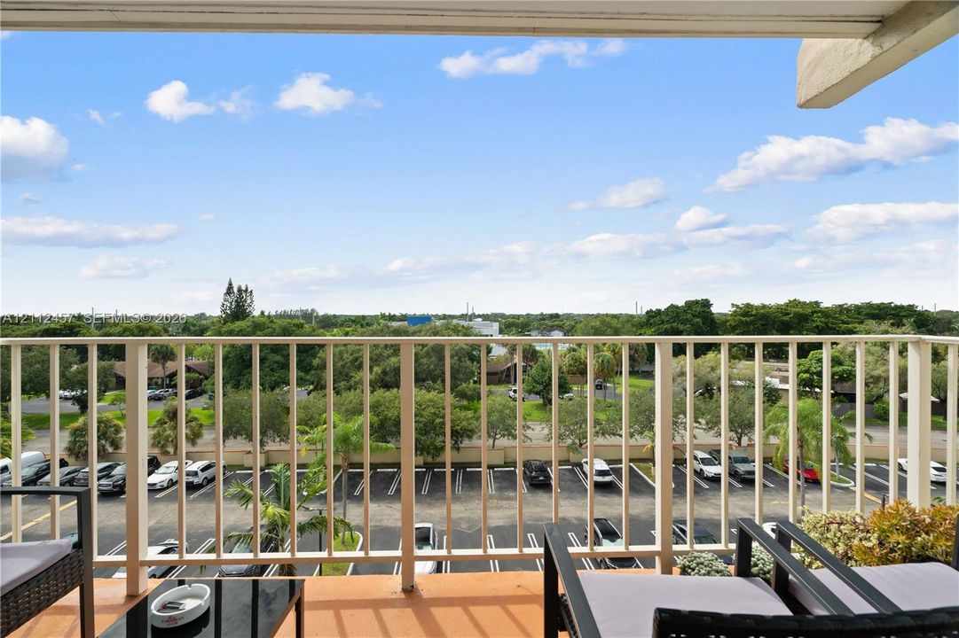 Covered balcony featuring metal railing and tile flooring