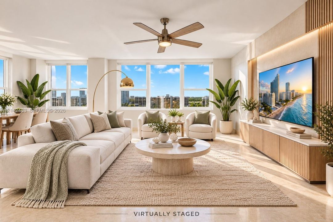 Living area featuring expansive windows, built-in wooden media cabinetry with integrated lighting, polished stone-finish flooring, and a central ceiling fan