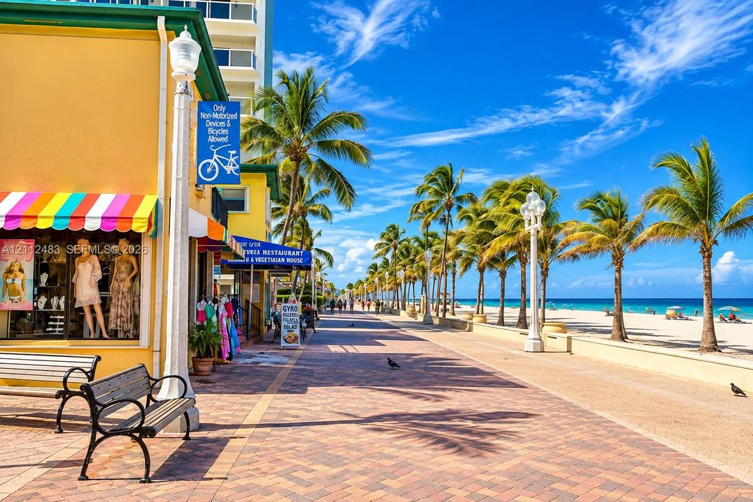 Paved brick promenade featuring ornate street lighting, mature palm trees, and direct access to a sand beach