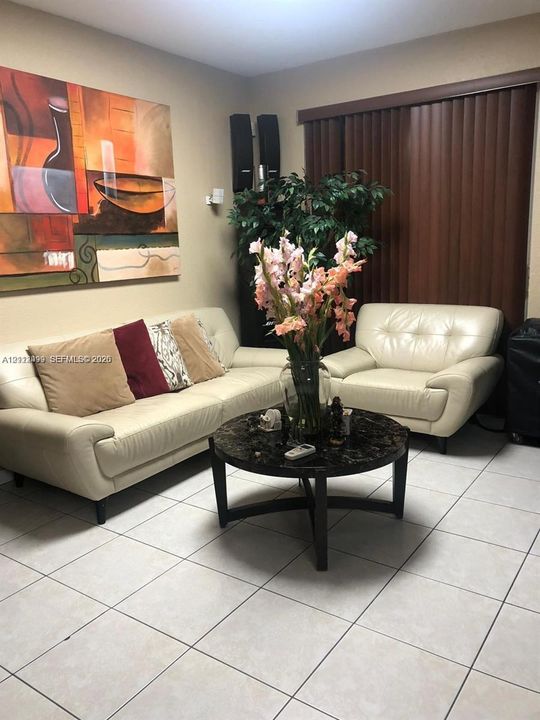 Ceramic tile flooring throughout and vertical window blinds