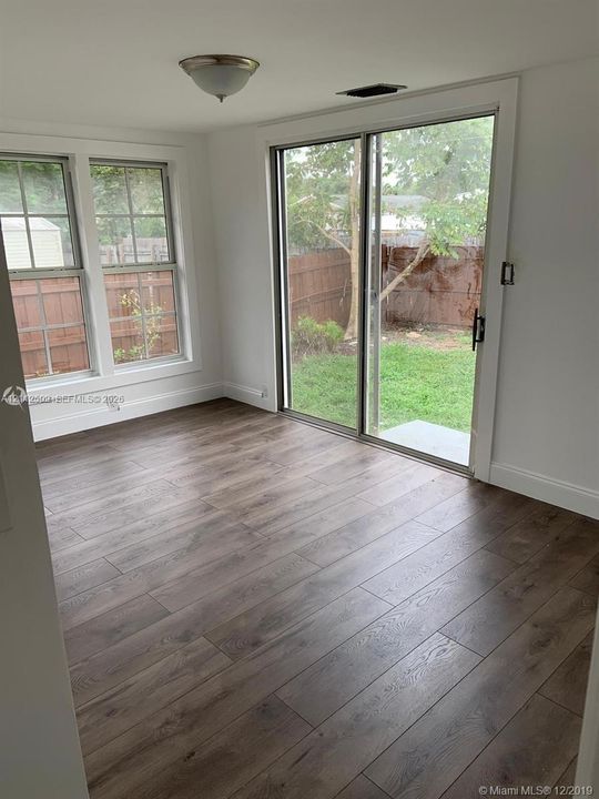 Wood-finish flooring, multi-pane windows, and sliding glass door