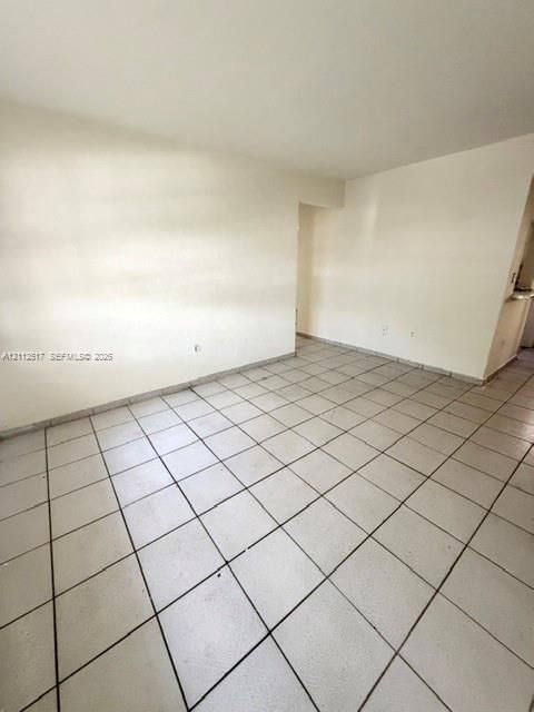 Neutral-toned interior featuring square ceramic tile flooring and light-painted wall surfaces