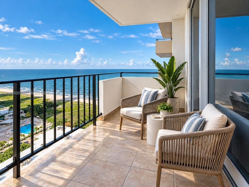 Private covered balcony featuring ceramic tile flooring, a black metal railing, and direct water access