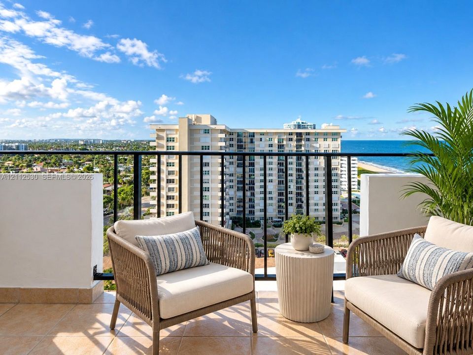 Private balcony featuring tile flooring and black metal railings with an unobstructed ocean and coastal horizon