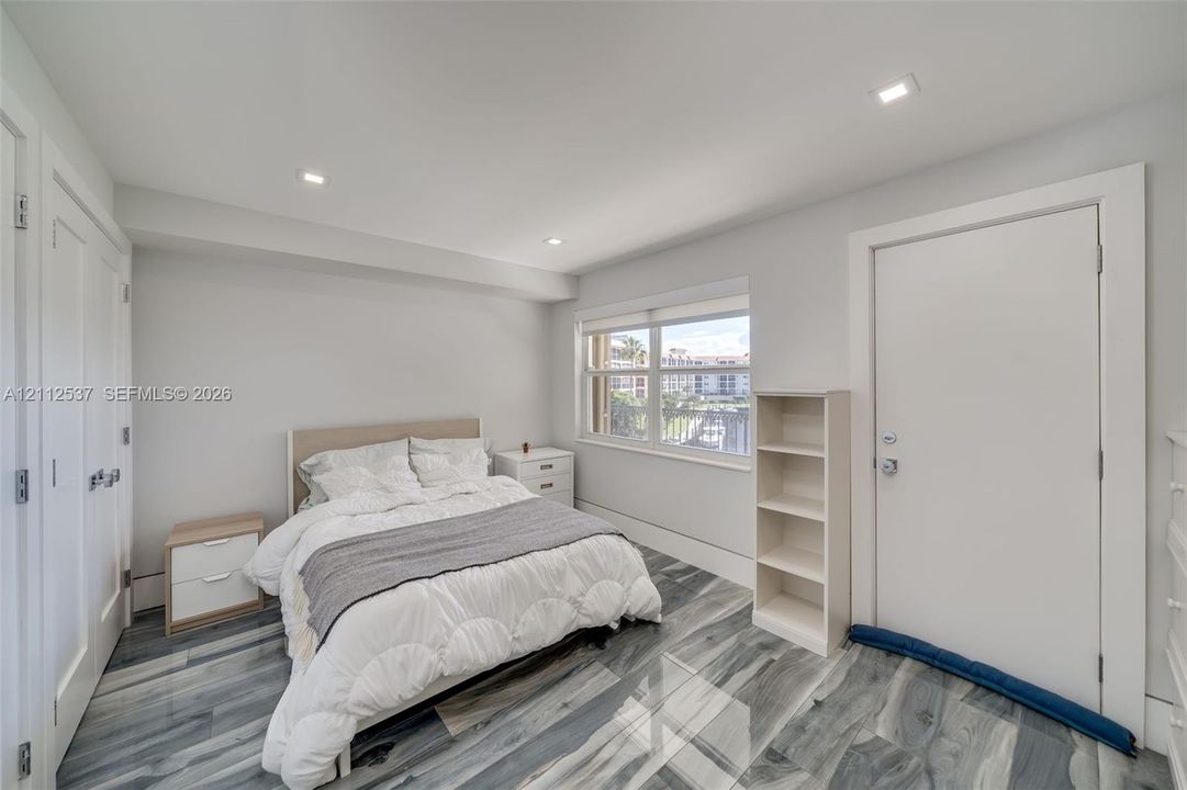 Room featuring wood-finish flooring, recessed lighting, and a multi-pane window