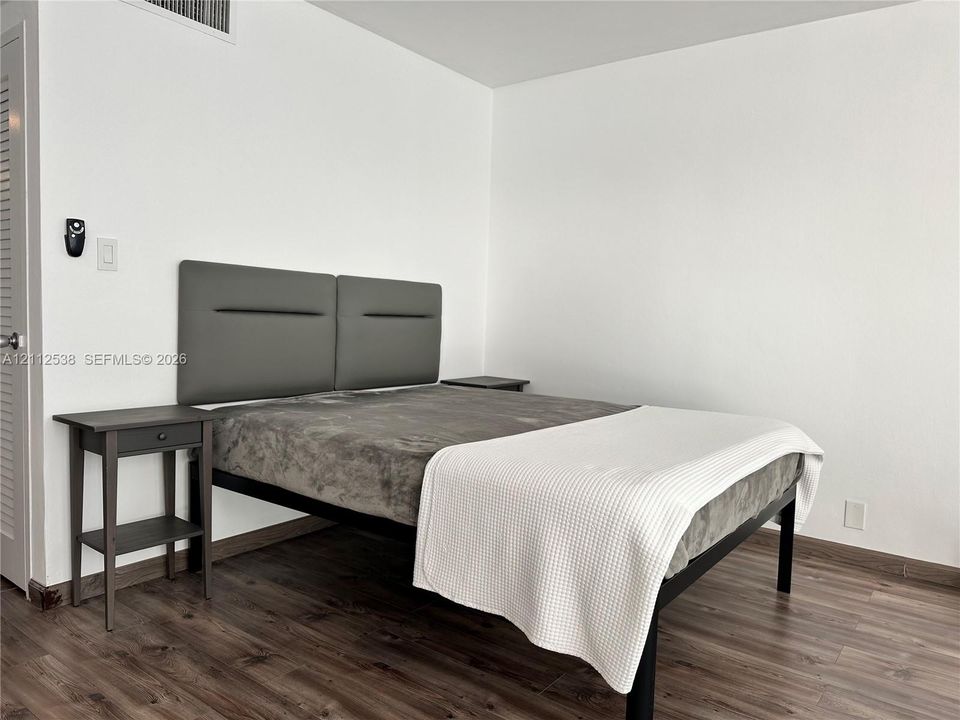 Neutral wall finishes, wood-finish flooring, and white interior trim