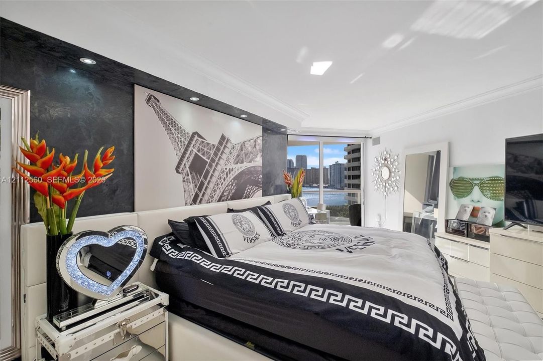 Textured charcoal feature wall with integrated recessed lighting, floor-to-ceiling glass sliding doors, and crown molding