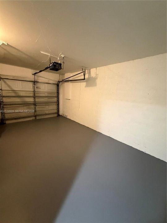 Garage space featuring a painted concrete floor
