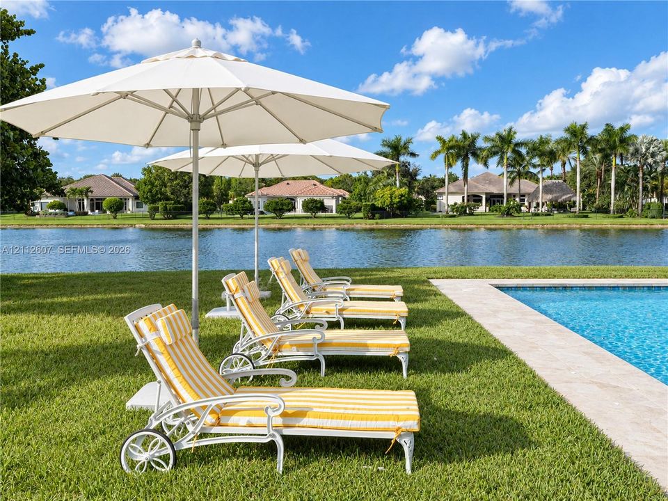 Swimming pool with natural stone decking and expansive waterfront lawn