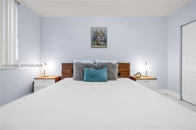 Room featuring vertical blinds, a solid-core interior door, and neutral-toned wall paint