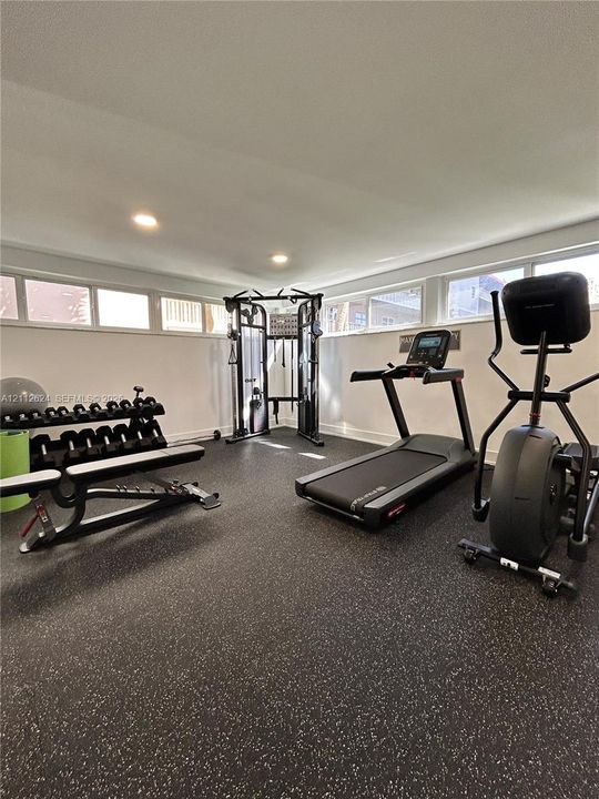 Flex space featuring speckled rubberized flooring, recessed lighting, and horizontal clerestory windows