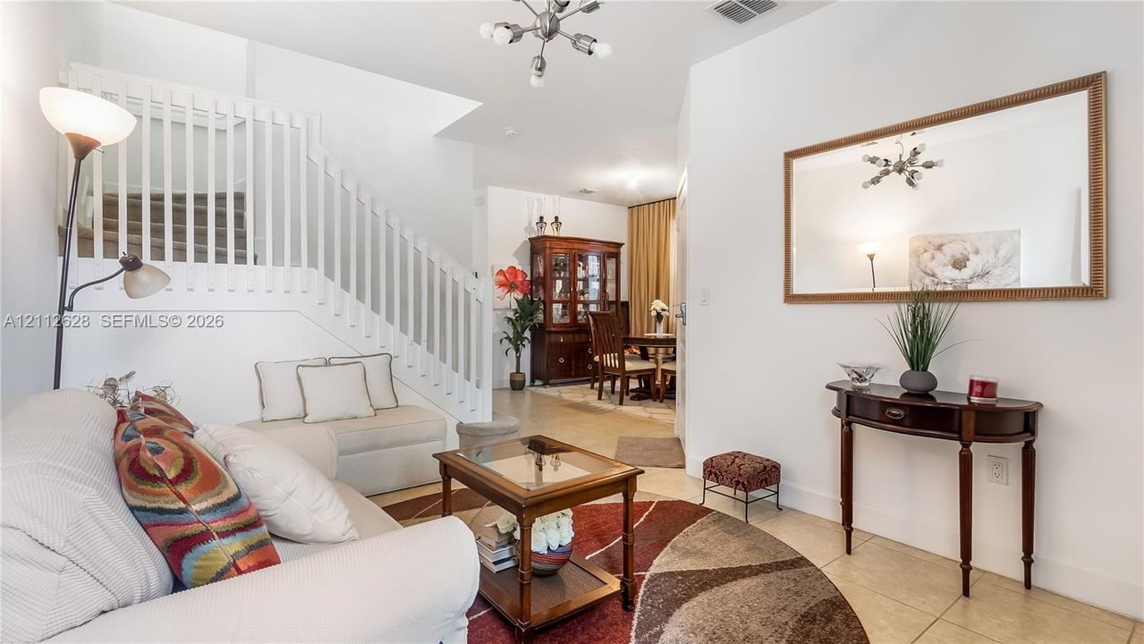 A stunning formal sitting room at the entrance creates a warm, luxurious first impression, offering a serene, upscale space reserved for your most special guests.