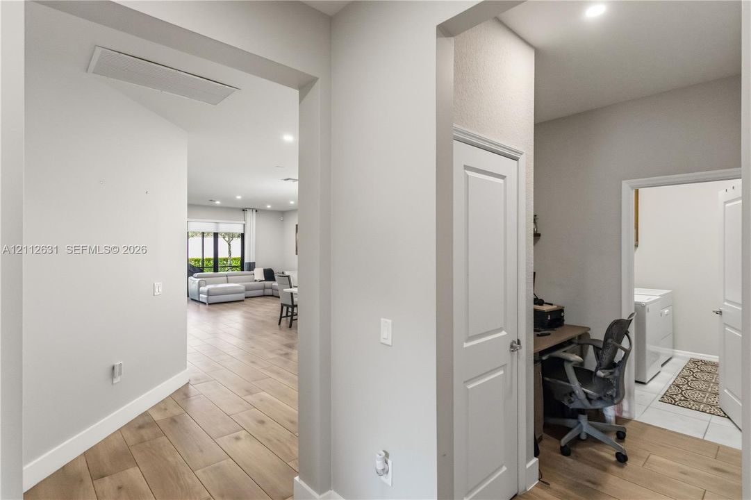 Interior featuring wood-finish flooring, recessed lighting, and crisp neutral wall paint