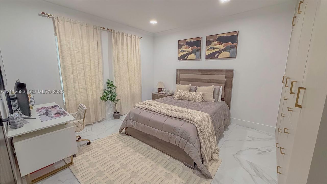 Neutral-toned interior featuring large-format tile flooring with a veined pattern, recessed ceiling lighting, and floor-to-ceiling built-in cabinetry with metallic hardware