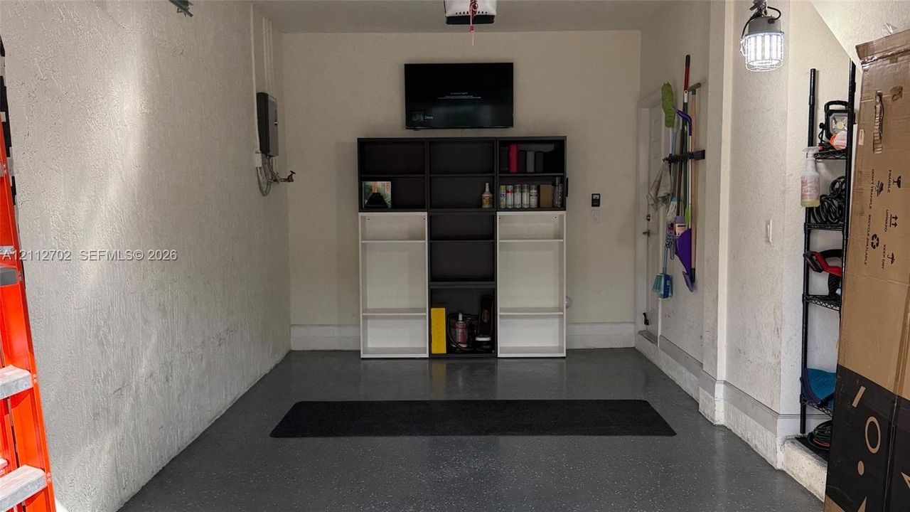 Garage space featuring durable epoxy flooring and high-output overhead task lighting