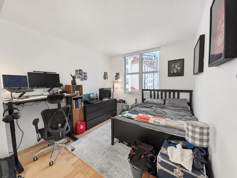 Light-filled room featuring wood-finish flooring and large picture window