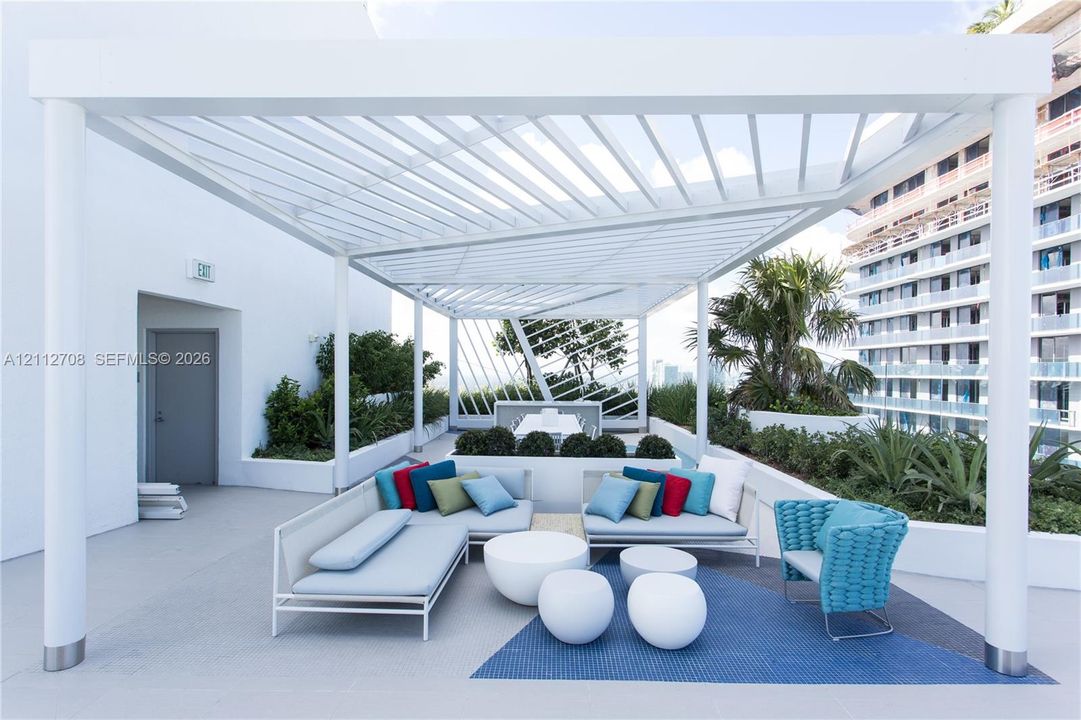 Rooftop terrace featuring a white metal pergola