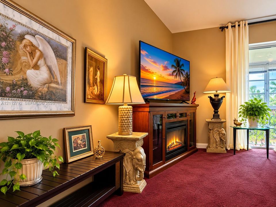 Built-in fireplace console with wood cabinetry, vaulted ceiling, and glass-paneled patio door with full-length drapery
