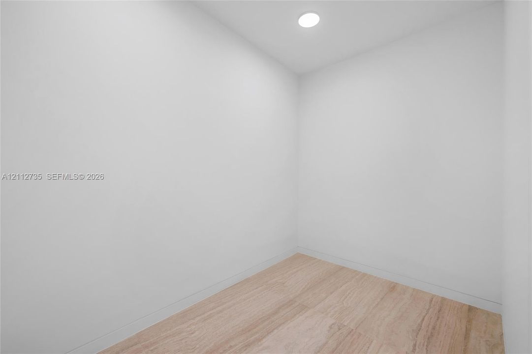 Neutral-toned interior space featuring light-colored wood-finish flooring and recessed ceiling lighting