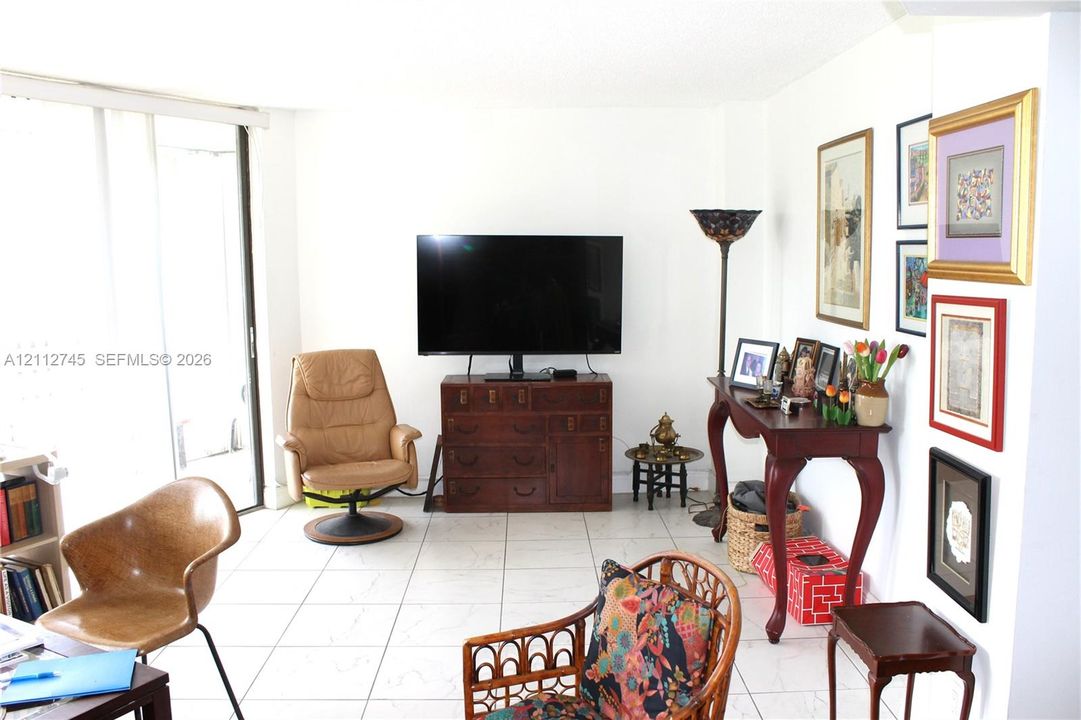 Interior living space featuring ceramic tile flooring and sliding glass doors