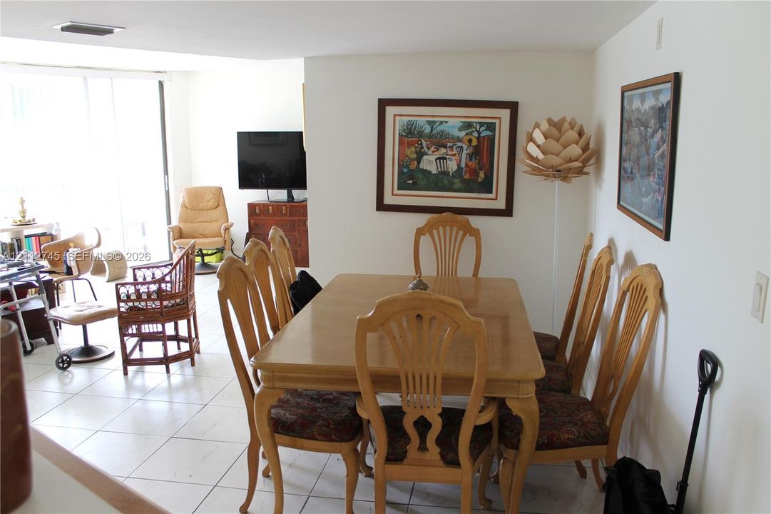 Neutral-toned ceramic tile flooring throughout, recessed ceiling lighting, and floor-to-ceiling glass sliding doors