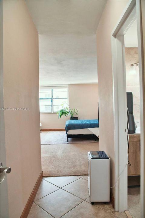 Tile flooring, wall-to-wall carpeting, and a multi-pane window