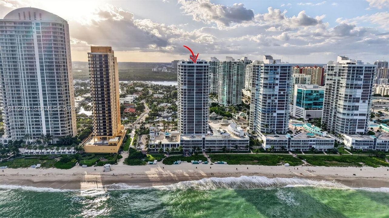 High-rise residential tower featuring direct oceanfront positioning and exterior balconies