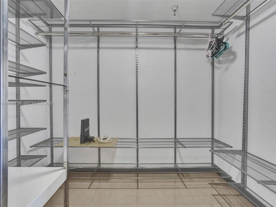 Built-in metal wire shelving system featuring tiered storage racks, integrated hanging rods, and an adjustable modular frame