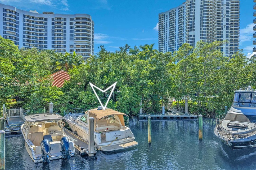 Deep-water canal frontage featuring a dedicated boat slip with pilings