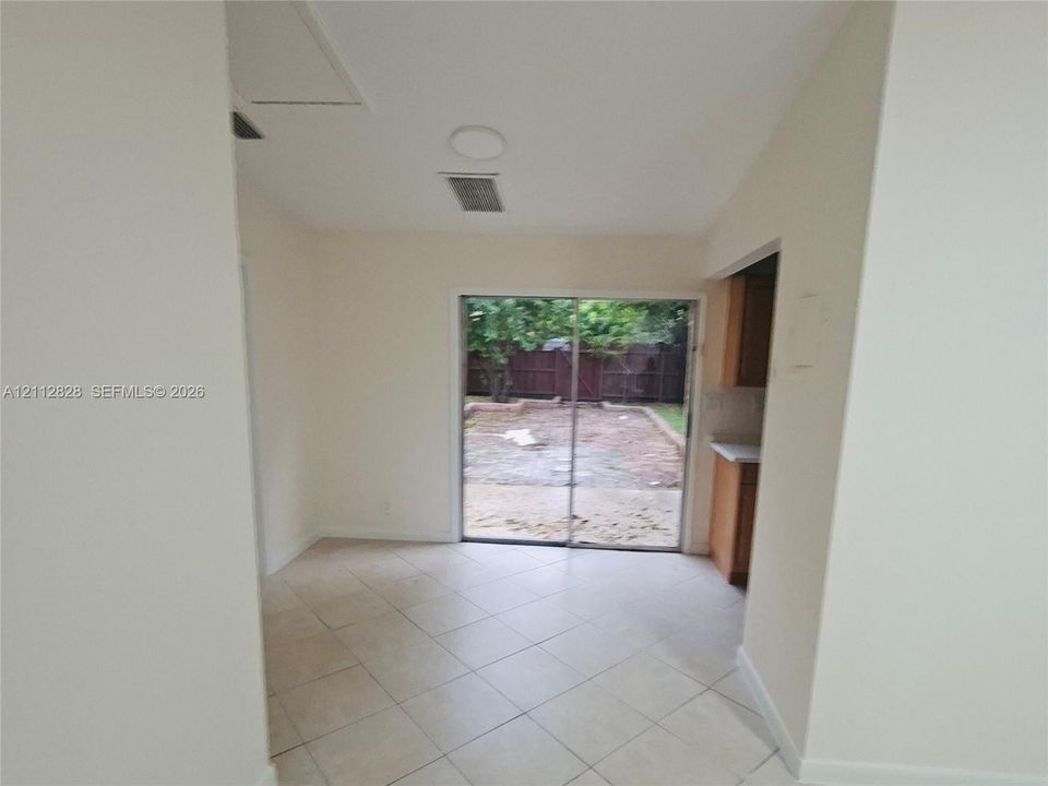Tile flooring, sliding glass door, and a concrete rear patio