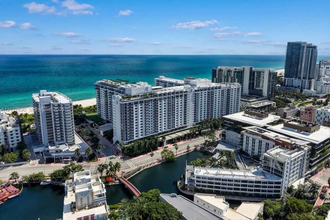Aerial perspective featuring coastal proximity, high-rise architecture, urban infrastructure, and waterway access
